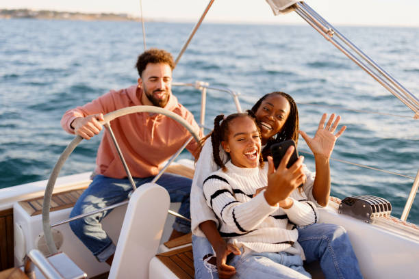 istock Cute family on a video call while yacht sailing 1449896262