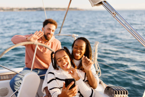 Cute family on a video call while yacht sailing