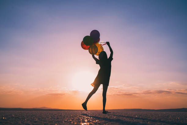 young woman dancing at gorgeous sunset