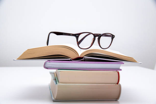 istock Stack of books with glasses on top of them 1449904953