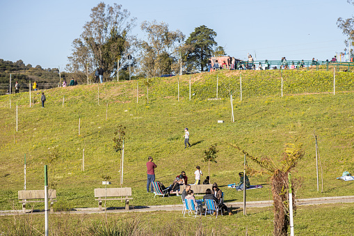 Caxias do Sul, Rio Grande do Sul, Brazil - 24th Sep, 2022 - People resting on grass in a sunny day at Ecopark (Ecoparque)