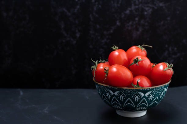 istock Side view of a set of cherry tomatoes in a container. 1449922709