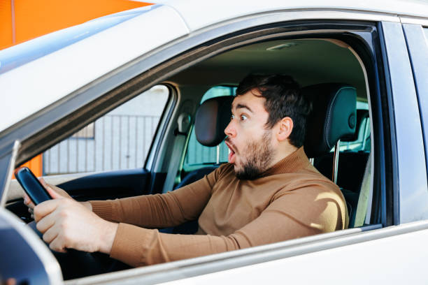 istock Sincere surprise and joy is experienced by a young guy behind the wheel. 1449938030