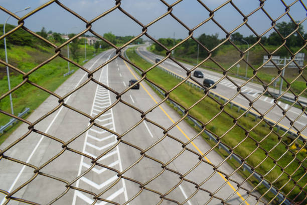 istock Chain link fence on the highway 1449950926