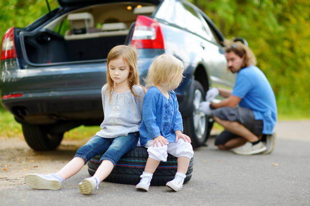istock Happy family changing a car wheel 1449951166