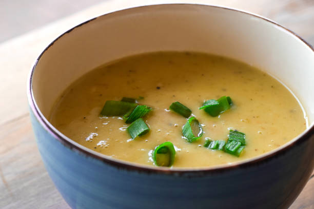 Bowl of leek potato soup garnished with green onions