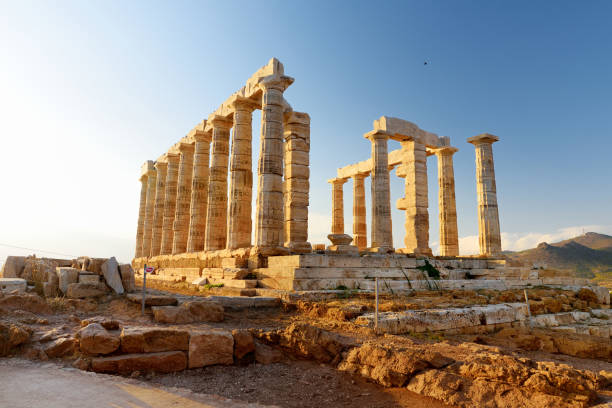 The Ancient Greek temple of Poseidon at Cape Sounion, one of the major monuments of the Golden Age of Athens. The Ancient Greek temple of Poseidon at Cape Sounion, one of the major monuments of the Golden Age of Athens. Scenic temple ruins with Doric-style columns, offering sweeping views of the sea. ancient greece stock pictures, royalty-free photos & images