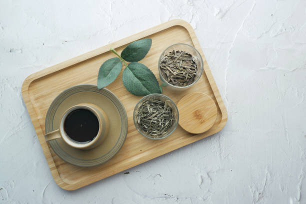 Dry tea leaves on spoon close up
