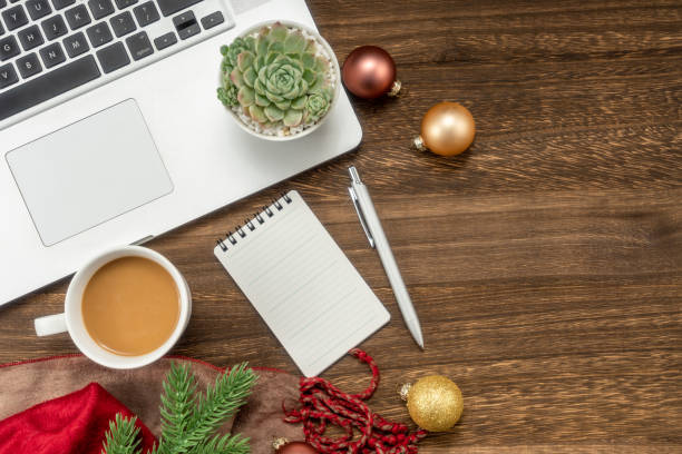istock Christmas background with Laptop, blank notebook, fir branches, decorations. Space for text. Top view. Christmas to-do list or wish list. 1449958380