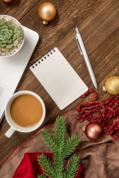 istock Christmas background with Laptop, blank notebook, fir branches, decorations. Space for text. Top view. Christmas to-do list or wish list. 1449958981