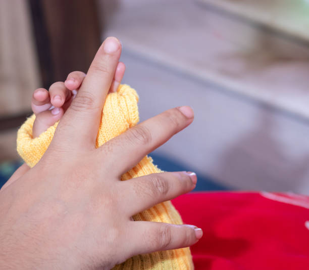 istock mother and baby finger touching together from flat angle 1449960613
