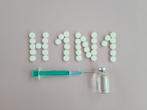 H1N1 medical tablet diagnosis. Syringe and vaccine with drugs and swine flu