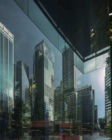 low angle of a high-rise office building inside a reflection of a building