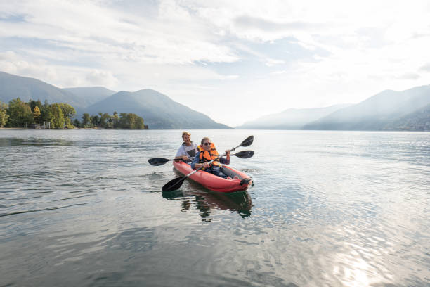istock Father and son canoeing on tranquil lake 1449976660