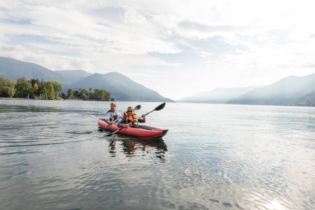 istock Father and son canoeing on tranquil lake 1449976662