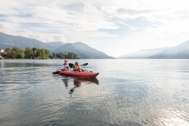 istock Father and son canoeing on tranquil lake 1449976664
