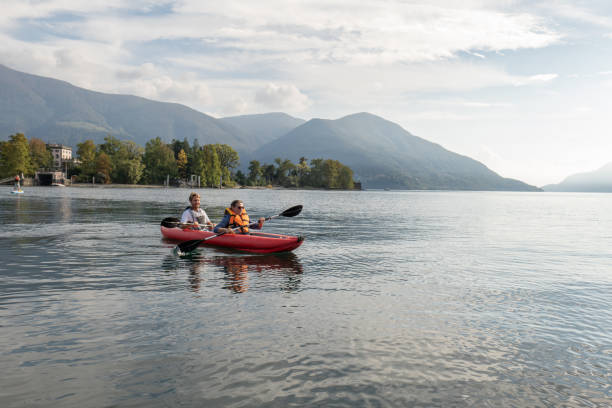 istock Father and son canoeing on tranquil lake 1449976712