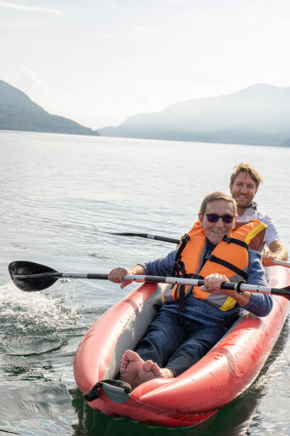 istock Father and son canoeing on tranquil lake 1449976739
