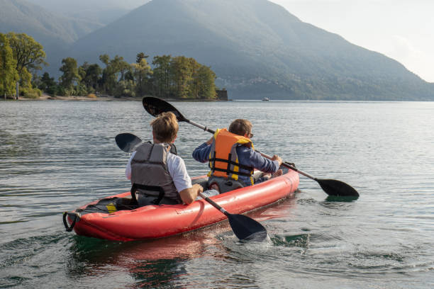 istock Father and son canoeing on tranquil lake 1449976811