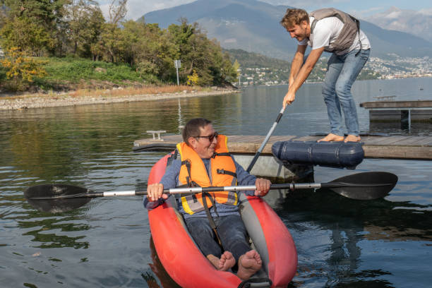 istock Young man volunteering taking senior citizen on a canoe trip 1449977462
