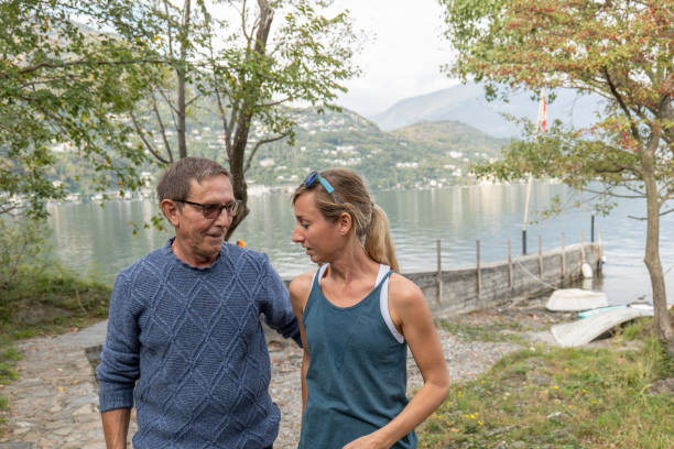 istock Volunteer taking senior citizen for a walk in the park 1449977694