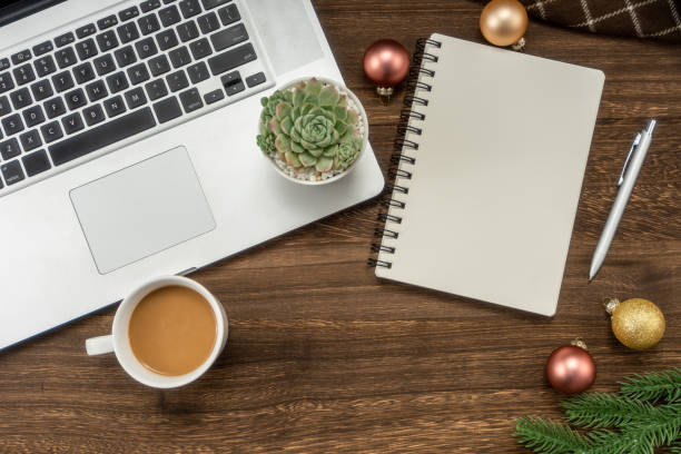 istock Laptop computer and notebook with Christmas decorations. Christmas mock up template. View from above 1449978753