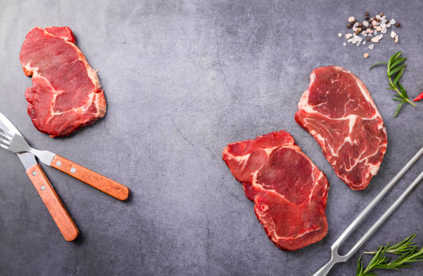 istock Fresh beef steak on a concrete background 1449981728