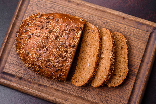 istock Delicious crispy bread with cereals on a wooden cutting board 1449987308