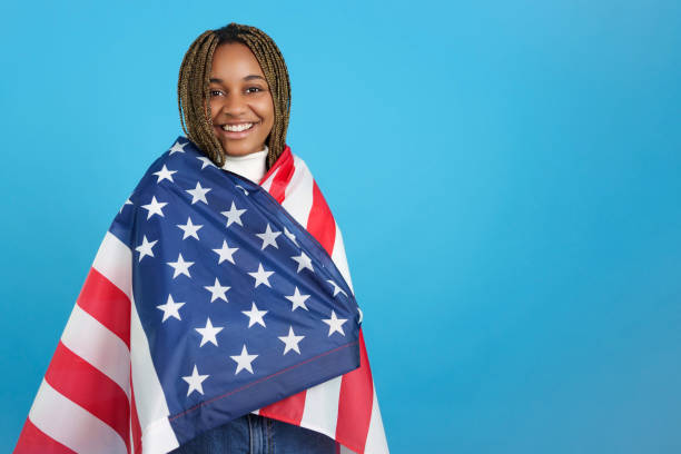 istock African woman wrapped in an US flag 1449989290