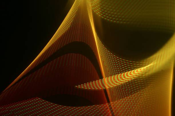 istock Orange and gold flowing waves on black background. Glowing motion lines backdrop 1449989409