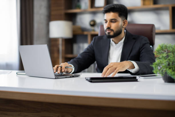 istock Confident businessman wearing suit writing notes or financial report 1449990463