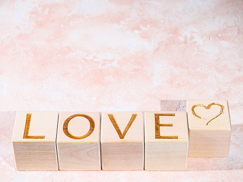 Text LOVE on wood blocks as concept of expressions of sentiment