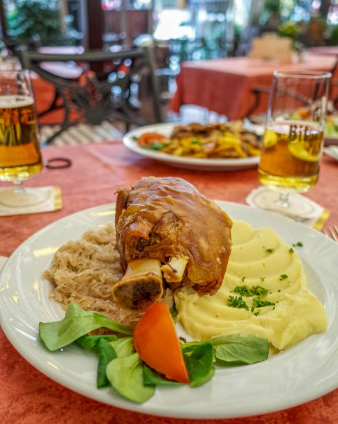 German Pork Knuckle German pork knuckle served with pickled cabbage and mashed potatoes pork hock stock pictures, royalty-free photos & images