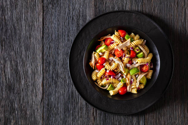 istock Chicken Pasta Salad with Avocado, Tomato in bowl 1449997735