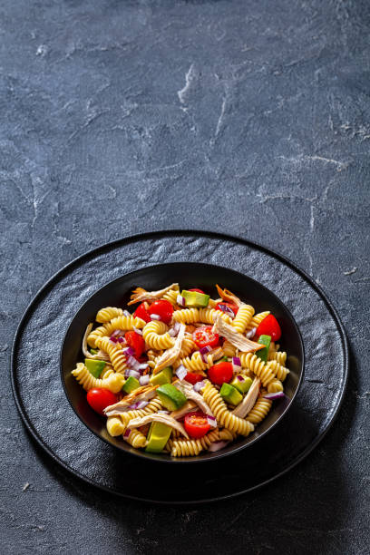 istock Chicken Pasta Salad with Avocado, Tomato in bowl 1449997753