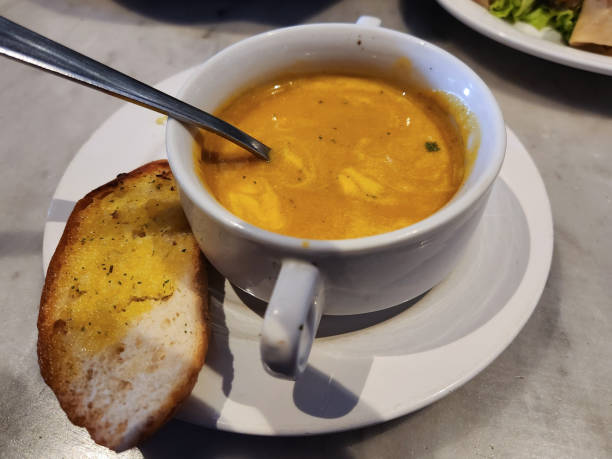 istock Pumpkin Soup with Garlic Toast served in a white bowl 1450005237