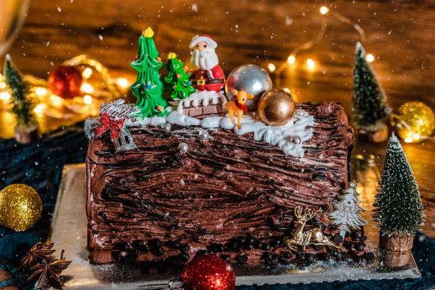 istock Closeup shot of a decorative chocolate Christmas cake with brown icing and holiday toppings 1450007708