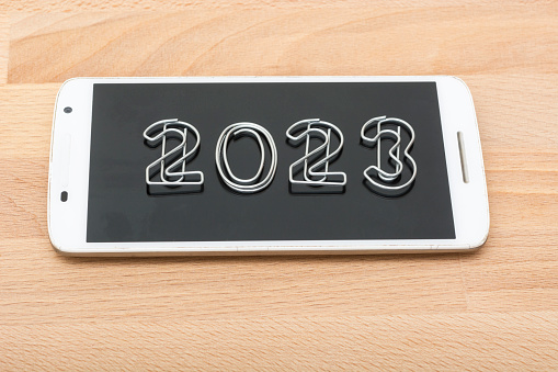 Smartphone with number 2023 on the screen. Decoration. New year. Technology