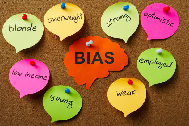 Pinned paper brain with word bias and stickers around. stock photo