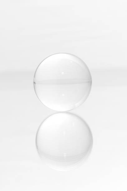 istock Glass ball on a mirrored surface and white background. 1450012534