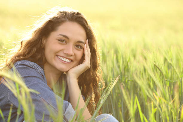 istock Happy woman smiling at camera in a wheat field 1450016152