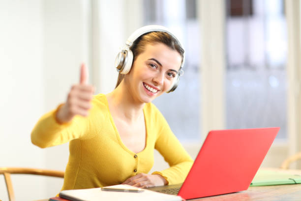 istock Happy student at home with thumbs up 1450016196