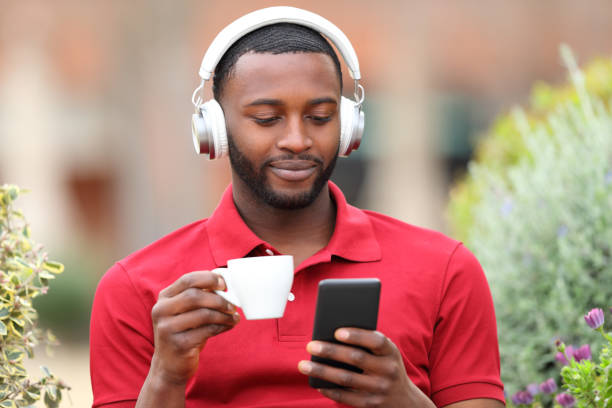 istock Black man checking music on phone 1450016273