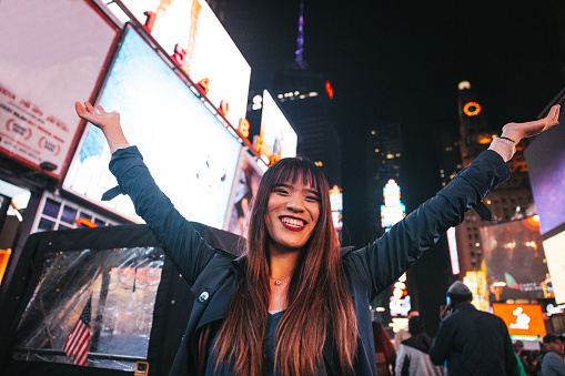Midtown New York, young Taiwanese tourist woman  spending a night in Times Square.
