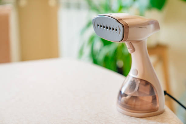 istock portable hand steamer for clothes. steam for ironing clothes. 1450017041