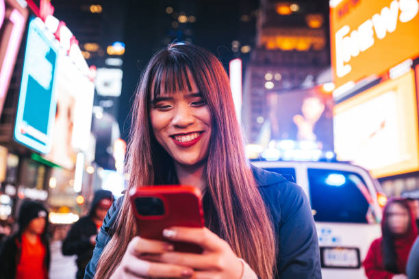 Woman texting on mobile in Times Square