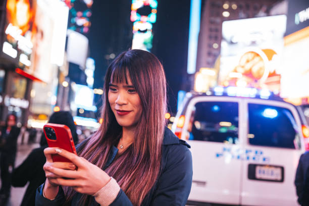 istock Woman texting on mobile in Times Square 1450017249