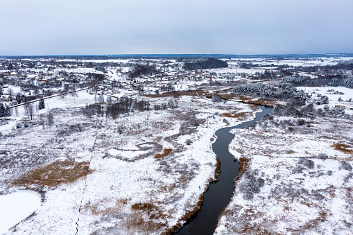 Panoramic Latvian winter landscape with Abava river flowing through the plain near Kandava