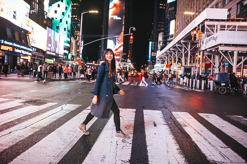 Midtown New York, young Taiwanese tourist woman  spending a night in Times Square.