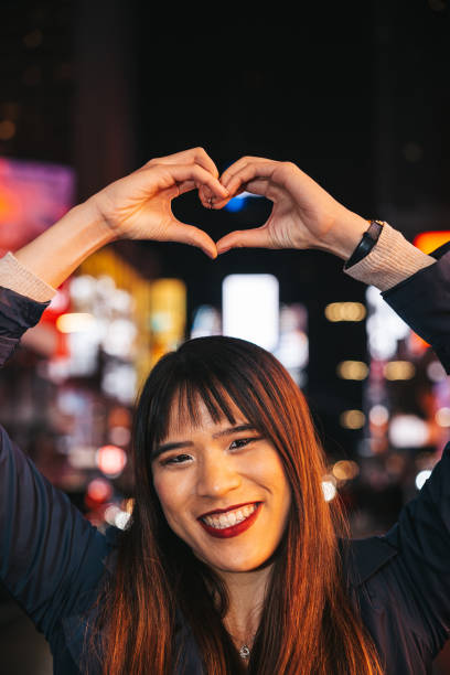 istock Taiwanese woman making a heart shape to camera 1450017655